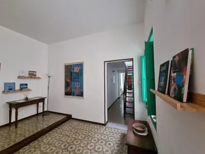 a room with a hallway with a table and a door at Piazza Politeama in Palermo