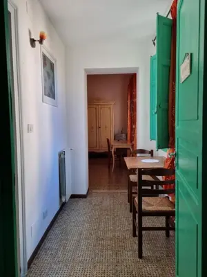 a room with a table and some green cabinets at Piazza Politeama in Palermo