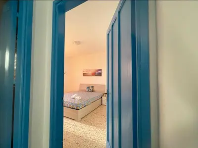 a door leading into a bedroom with a bed at Appartamento Ponente in Balestrate