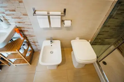 a bathroom with a toilet and a sink at Bed à Cala in Palermo