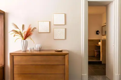 a hallway with a wooden dresser with a plant on it at Crispi Apartments in Palermo