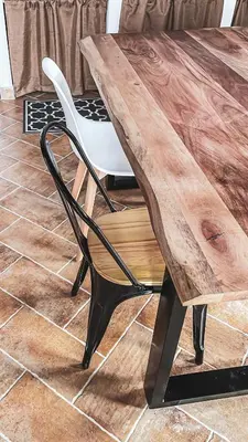 a wooden table and a white chair next to a table at Alla Riserva - Villa Riserva dello Zingaro - Scopello in Scopello