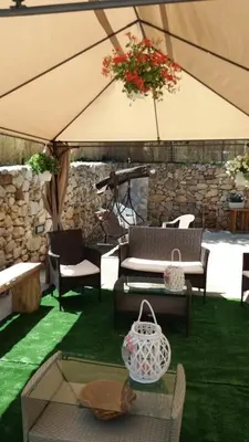 a bedroom with a green bed with two towels on it at appartamento in villa splendente in Castellammare del Golfo