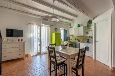 a kitchen with a table and chairs in a room at Sant'Onofrio Apartments by Wonderful Italy in Palermo