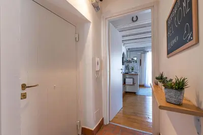 a hallway with a white door leading to a hallway with a hallway at Sant'Onofrio Apartments by Wonderful Italy in Palermo