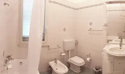 a white bathroom with a toilet and a sink at Contessa Vacanze Byron in Contessa Entellina
