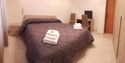 a bedroom with a bed with two towels on it at Contessa Vacanze Byron in Contessa Entellina