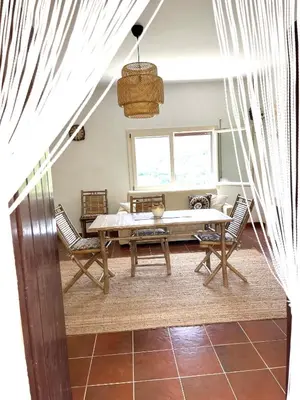 a dining room with a table and chairs at Villetta con Oliveto CFG in Prizzi