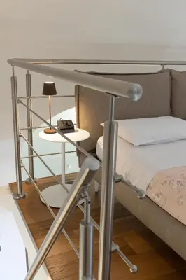 a bedroom with a bed and a table with a lamp at Peonia Boutique Apartments in Palermo