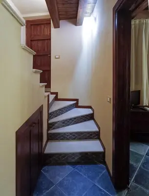 a staircase in a house with blue tile floors at Casa all'Annunziata in Termini Imerese