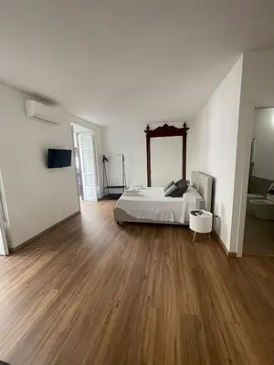 a bedroom with a bed and a wooden floor at Quattrocantiapartments in Palermo