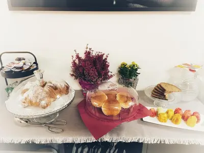 a table with a tray of bread and a plate of food at Nostrale bnb in Palermo