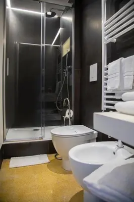 a bathroom with a shower and a toilet and a sink at Nostrale bnb in Palermo