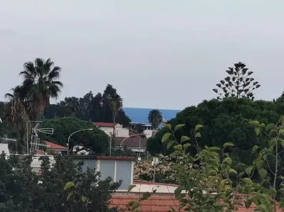 a view of a city with trees and buildings at Villa Iris - Mondello in Palermo
