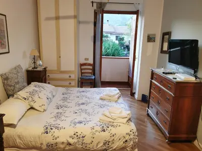 a bedroom with a bed and a dresser and a television at Villa Iris - Mondello in Palermo