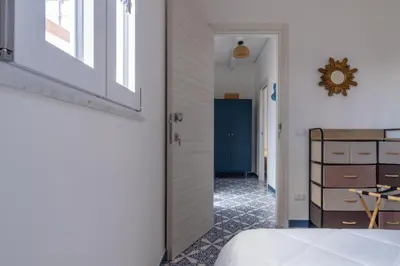 a bedroom with a white bed with towels on it at Zisa Top Romantic Terrace & Private outdoor Jacuzzi in Palermo