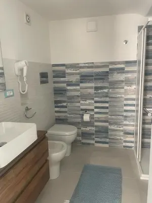 a bathroom with a toilet and a sink and a shower at appartamento francy solare in Castellammare del Golfo