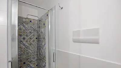 a shower with a glass door in a bathroom at Bonello House Cattedrale in Palermo
