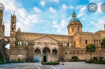 a large building with a clock tower on top at POLITEAMA SUITE IN THE HEART OF THE CITY in Palermo