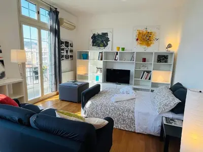 a living room with a bed and a couch at POLITEAMA SUITE IN THE HEART OF THE CITY in Palermo