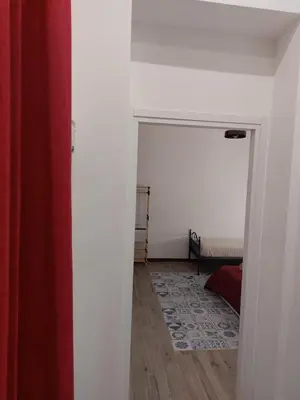 a hallway with a room with a bed and a door at HouseStation Suite in Palermo