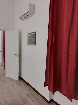 a room with a red curtain on a wall at HouseStation Suite in Palermo