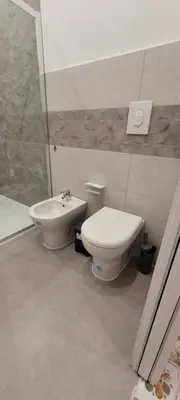 a bathroom with a toilet and a sink at HouseStation Suite in Palermo