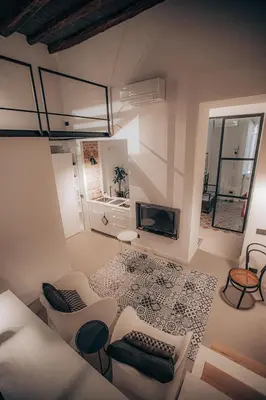 a living room with white furniture and a fireplace at Casa 3D'Oro Palermo in Palermo
