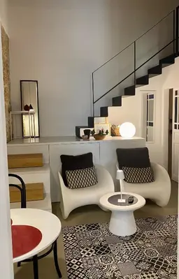 a living room with two chairs and a table at Casa 3D'Oro Palermo in Palermo