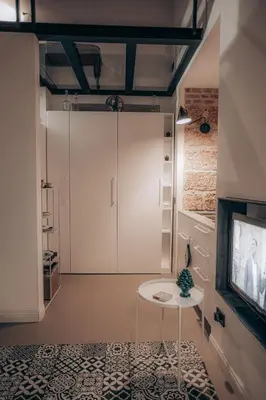 a room with a door and a table and a tv at Casa 3D'Oro Palermo in Palermo