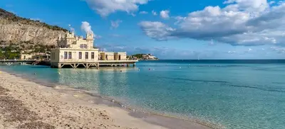 a building on a beach next to the water at Appartamento Rebecca in Palermo
