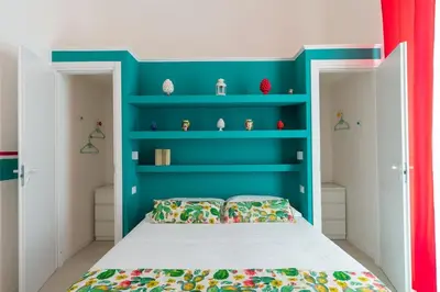 a living room with a table and chairs and a tv at Briaria Apartment in Palermo