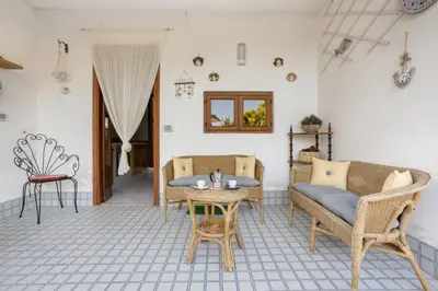 a living room with chairs and a table at Solemar Sicilia - Villa Corallo in Bagheria