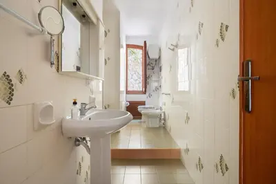 a bathroom with a sink and a toilet at Solemar Sicilia - Villa Corallo in Bagheria