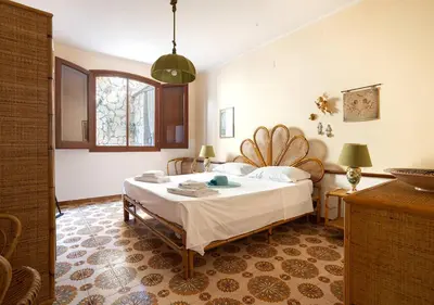 a bedroom with a large bed in a room at Solemar Sicilia - Villa Corallo in Bagheria