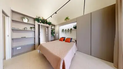 a bedroom with a bed with orange pillows at Carletta's Aparta-Suite & Spa in Palermo