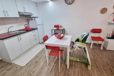 a kitchen with a table and red chairs in a kitchen at Simply the best - apartment and parking space by Balsamotto in Palermo