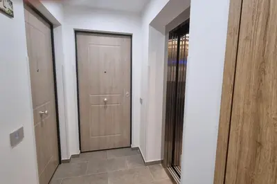 a hallway with two wooden doors and a tile floor at Simply the best - apartment and parking space by Balsamotto in Palermo