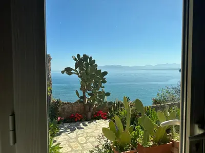 a view of the ocean from a house door at Terrazza sul mare Scopello in Scopello