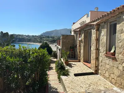 a stone house with a view of the water at Terrazza sul mare Scopello in Scopello
