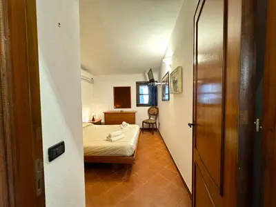 a small room with a bed and a small hallway at Villa Talìa in Carini
