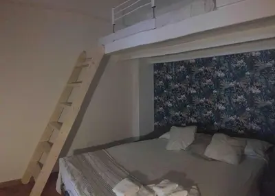 a bedroom with a bunk bed with a ladder at Alloggio incantevole/ bedsitting-room in Altavilla Milicia