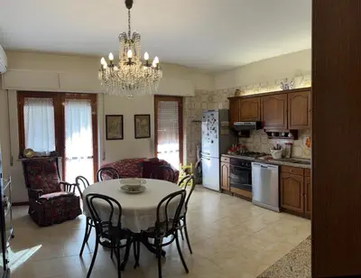 a kitchen and dining room with a table and chairs at Holiday & House - Imparato Palermo Centro Politeama in Palermo