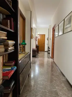 a hallway with a book shelf and a hallway with a room with at Holiday & House - Imparato Palermo Centro Politeama in Palermo