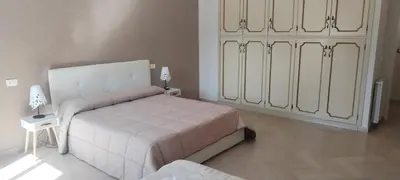 a bedroom with two beds and a dresser and a window at SUITE PRINCIPE SCORDIA in Palermo