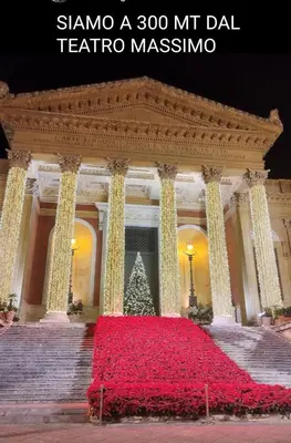 a building with a christmas tree in front of it at SUITE PRINCIPE SCORDIA in Palermo