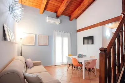 a living room with a couch and a table at Happie Casa La Cattedrale in Palermo