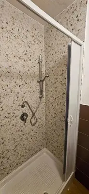 a shower with a shower head in a bathroom at Happie Casa La Cattedrale in Palermo