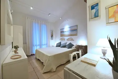 a bedroom with a bed and a table in a room at Villa Fenice in Scopello