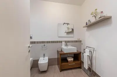 a bathroom with a toilet and a sink at Borsa Apartments by Wonderful Italy in Palermo